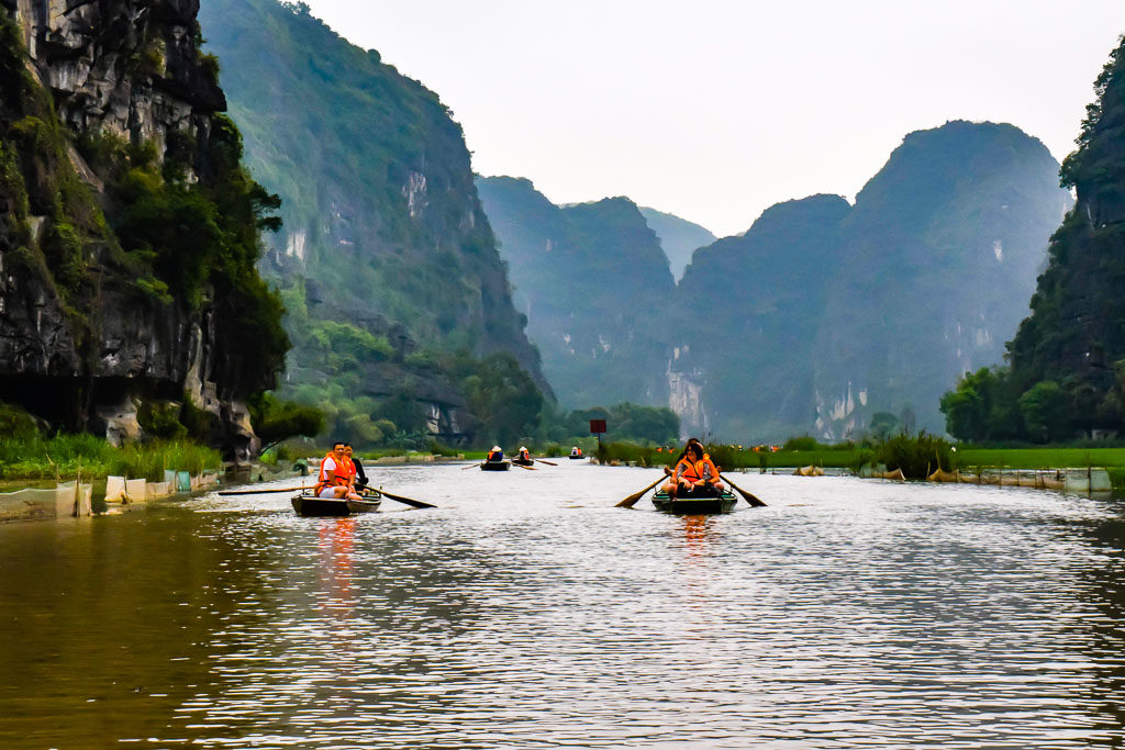 taking row boats to the cave Boat Cave Tour