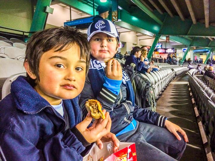 Australian Rules Football eating a meat pie